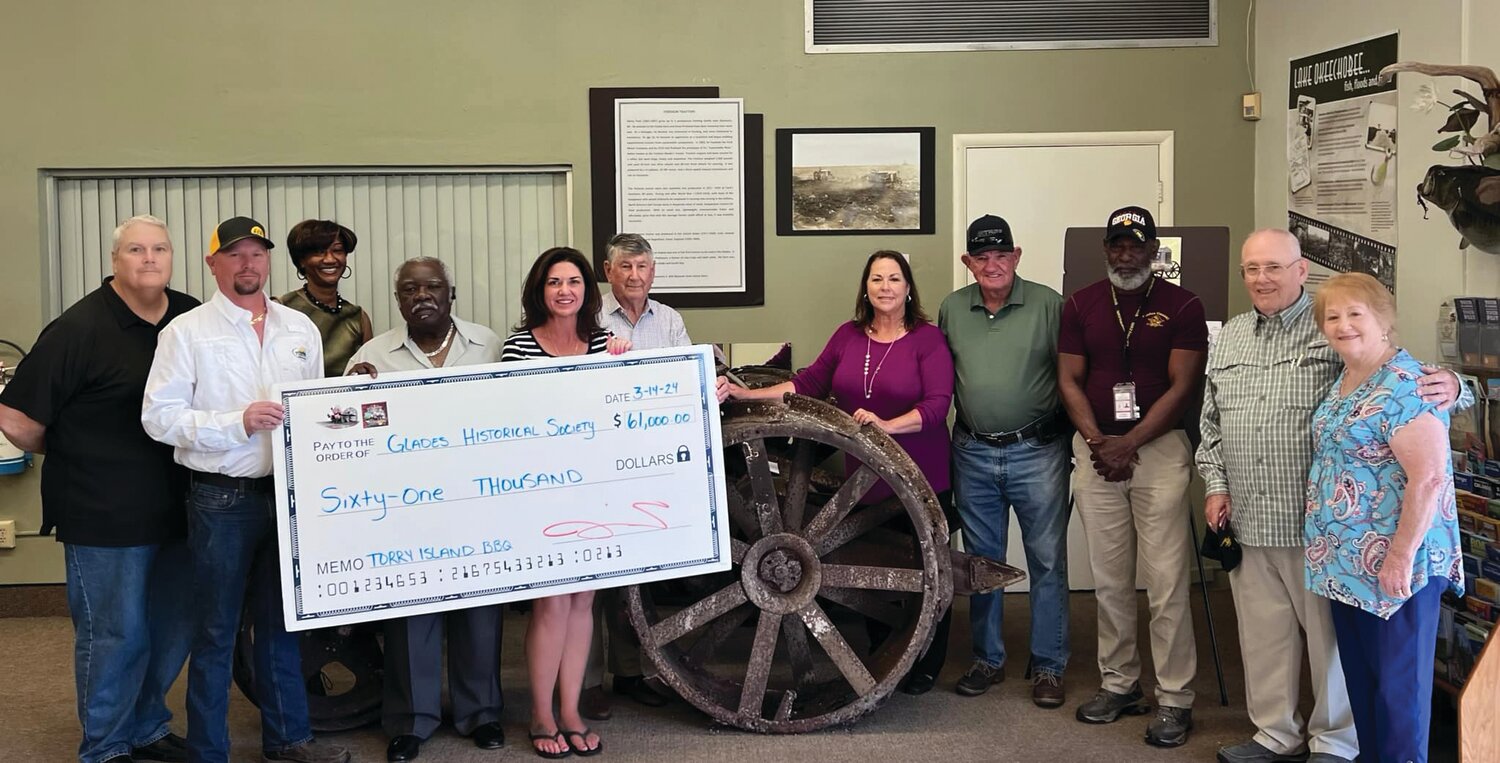 BELLE GLADE -- On March 14,  Jennifer Earnest, Kevin Brewer, Kevin Rhodes and Lamar Weathers from the Torry Island BBQ Committee presented the Glades Historical Society a check for $61,000. They are excited that the funds will get the Glades NFL Hall of Fame built and new upgrades to the Lawrence E. Will Museum! The Glades Historical Society’s representative, Cheryl Stein said “The NFL Hall of Fame & the Hall of Distinction are most definitely on the way!! The Historical Society was overwhelmed with the generosity of the fundraiser & all who were a part of it.” Left to right are Lamar Weathers, Kevin Brewer, Brenda Bryant, Eddie Rhodes, Jennifer Earnest, Steve Weekes, Cheryl Stein, Willie Lee, J.D. Patrick & Mr. & Mrs. Johnny Hood. [Courtesy photo]